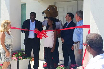 HOMES, Inc. recently celebrate a new home with a ribbon cutting.
